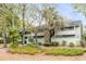 Charming exterior view showcasing the building's architecture amidst mature trees and landscaping at 1174 Village Creek Ln # 3, Mount Pleasant, SC 29464