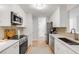 Modern kitchen with stainless steel appliances, white cabinets, tile backsplash, and hardwood floors at 1174 Village Creek Ln # 3, Mount Pleasant, SC 29464