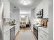 Bright kitchen features white cabinets, stainless steel appliances, and an opening to the dining area at 1174 Village Creek Ln # 3, Mount Pleasant, SC 29464