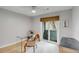 Bright home office with glass desk, natural light, and door to balcony at 1174 Village Creek Ln # 3, Mount Pleasant, SC 29464