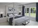 Serene main bedroom featuring a four poster bed, soft colors, and lots of natural light from the picture windows at 118 Threaded Fern St, Summerville, SC 29485