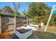 Backyard with wooden fencing, mature trees, and planter beds for gardening and landscaping at 12 Poplar St, Charleston, SC 29403