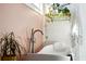 Luxurious bathroom featuring a soaking tub, towel rack, and natural light from nearby windows at 12 Poplar St, Charleston, SC 29403