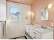 Elegant bathroom with a double vanity, marble countertop, and gold fixtures complemented by a blush accent wall at 12 Poplar St, Charleston, SC 29403