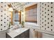 Charming bathroom with bee wallpaper, window, and marble countertop at 12 Poplar St, Charleston, SC 29403