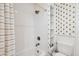 Bathroom with a tub and shower combo, white tile and open shelving at 12 Poplar St, Charleston, SC 29403