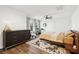Bright and airy bedroom with modern decor, ceiling fan, hard wood floors, and natural light at 12 Poplar St, Charleston, SC 29403