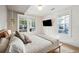 Bright bedroom with two windows, wood floors, and a comfortable bed at 12 Poplar St, Charleston, SC 29403