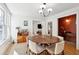 Cozy dining room featuring a modern chandelier, hardwood floors, and nearby wet bar for entertainment at 12 Poplar St, Charleston, SC 29403