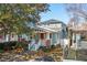 Inviting two-story home with a charming front porch, red door, and beautifully landscaped yard at 12 Poplar St, Charleston, SC 29403