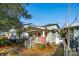 Charming home featuring a cozy front porch, brick accents, and mature trees at 12 Poplar St, Charleston, SC 29403