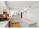 Bright, open kitchen with updated countertops, stainless steel appliances and hardwood floors at 12 Poplar St, Charleston, SC 29403