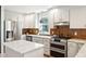 Well-appointed kitchen with stainless steel appliances and center island with seating at 12 Poplar St, Charleston, SC 29403
