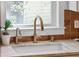 Close-up of kitchen sink with stylish fixture and window providing natural light at 12 Poplar St, Charleston, SC 29403