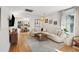 Bright living room with hardwood floors, recessed lighting, a large sofa, and view into the dining area at 12 Poplar St, Charleston, SC 29403
