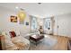 Sun-filled living room with hardwood floors, modern lighting, and a comfortable sofa at 12 Poplar St, Charleston, SC 29403