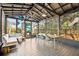 Covered patio with a comfortable couch and view of the green backyard at 12 Poplar St, Charleston, SC 29403