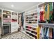Spacious walk-in closet featuring custom shelving, hanging rods, drawers, and a decorative rug at 12 Poplar St, Charleston, SC 29403