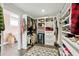 Well-organized walk-in closet with ample storage, including shelving, drawers, and a mirrored wine cooler at 12 Poplar St, Charleston, SC 29403
