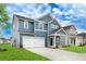 Beautiful two-story home featuring blue siding, white trim, and a well-maintained front lawn at 121 Moscato Ln, Summerville, SC 29485