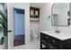 Bright bathroom boasts a modern vanity and a large mirror, complemented by stylish decor and ample space at 1239 Wappetaw Pl, Mount Pleasant, SC 29464