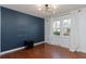 Stylish bedroom featuring a modern light fixture, accent wall, hardwood floors and bright window at 1239 Wappetaw Pl, Mount Pleasant, SC 29464