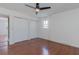 Bedroom with a double door closet and a large window. Hardwood floors and neutral paint at 1239 Wappetaw Pl, Mount Pleasant, SC 29464
