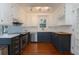 Well-lit kitchen features stainless steel appliances, dark-blue cabinets with gold handles, and white marble backsplash at 1239 Wappetaw Pl, Mount Pleasant, SC 29464