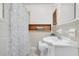 Bathroom featuring a vanity with sink, toilet, shower with curtain, storage cabinet, and neutral tile at 1442 N Sherwood Drive Dr, Charleston, SC 29407