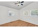 Bright bedroom featuring hardwood floors, neutral walls, a ceiling fan, and two windows for lots of natural light at 1442 N Sherwood Drive Dr, Charleston, SC 29407