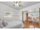 Bright bedroom featuring white walls, built-in shelves, and a connecting room with hardwood floors at 1442 N Sherwood Drive Dr, Charleston, SC 29407