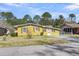 Charming one-story home with yellow siding, black shutters, and a well-manicured front yard at 1442 N Sherwood Drive Dr, Charleston, SC 29407