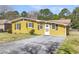 Attractive house with a sunny yellow exterior, neat landscaping, and a welcoming entrance, creating curb appeal at 1442 N Sherwood Drive Dr, Charleston, SC 29407