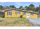 Charming yellow home exterior with a well-maintained lawn and classic shutters at 1442 N Sherwood Drive Dr, Charleston, SC 29407