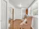 Hallway featuring hardwood floors, natural light, and glimpses into other rooms, creating an inviting space at 1442 N Sherwood Drive Dr, Charleston, SC 29407