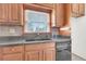 Kitchen view showcasing wood cabinets, granite countertops, tile backsplash, a stainless steel sink, and modern appliances at 1442 N Sherwood Drive Dr, Charleston, SC 29407