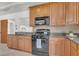 Kitchen features wooden cabinetry, black appliances, and dark countertops at 1442 N Sherwood Drive Dr, Charleston, SC 29407