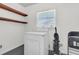 Functional laundry area with a dryer, floating shelves, and space-saving design for convenience at 1442 N Sherwood Drive Dr, Charleston, SC 29407