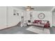 Comfortable living room with a red sofa, white rug, and a staircase, blending style and functionality at 1442 N Sherwood Drive Dr, Charleston, SC 29407