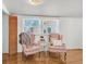 Cozy sitting area showcasing two armchairs, a small table, and natural light from the windows at 1442 N Sherwood Drive Dr, Charleston, SC 29407