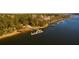 Aerial view of waterfront property featuring a private dock and lush landscaping at 1468 Alligator Creek Ct, Awendaw, SC 29429
