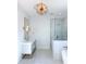 Elegant bathroom with a soaking tub, glass shower, and modern vanity with gold accents at 1468 Alligator Creek Ct, Awendaw, SC 29429