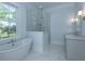 Bright bathroom with a freestanding tub, glass shower, and modern fixtures at 1468 Alligator Creek Ct, Awendaw, SC 29429
