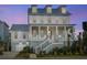 Beautiful two-story home featuring a welcoming front porch, landscaped yard, and a charming coastal design at 1468 Alligator Creek Ct, Awendaw, SC 29429