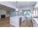 Open concept kitchen with a large island, stainless steel appliances, and hardwood floors at 1468 Alligator Creek Ct, Awendaw, SC 29429
