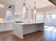 Gourmet kitchen with island, white cabinets, and stainless steel appliances at 1468 Alligator Creek Ct, Awendaw, SC 29429