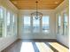 Bright living room with hardwood floors, natural light, and wood-paneled ceilings at 1468 Alligator Creek Ct, Awendaw, SC 29429