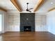 Living room with a fireplace, built-in shelving, and wooden beams at 1468 Alligator Creek Ct, Awendaw, SC 29429