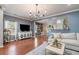 Spacious living room with hardwood floors seamlessly flowing into the dining area with ample seating at 1709 Restoration Ct, Charleston, SC 29414