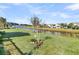 Expansive backyard view featuring a well-manicured lawn, pond, and houses with well-kept lawns at 174 Sea Lavender Ln, Summerville, SC 29486